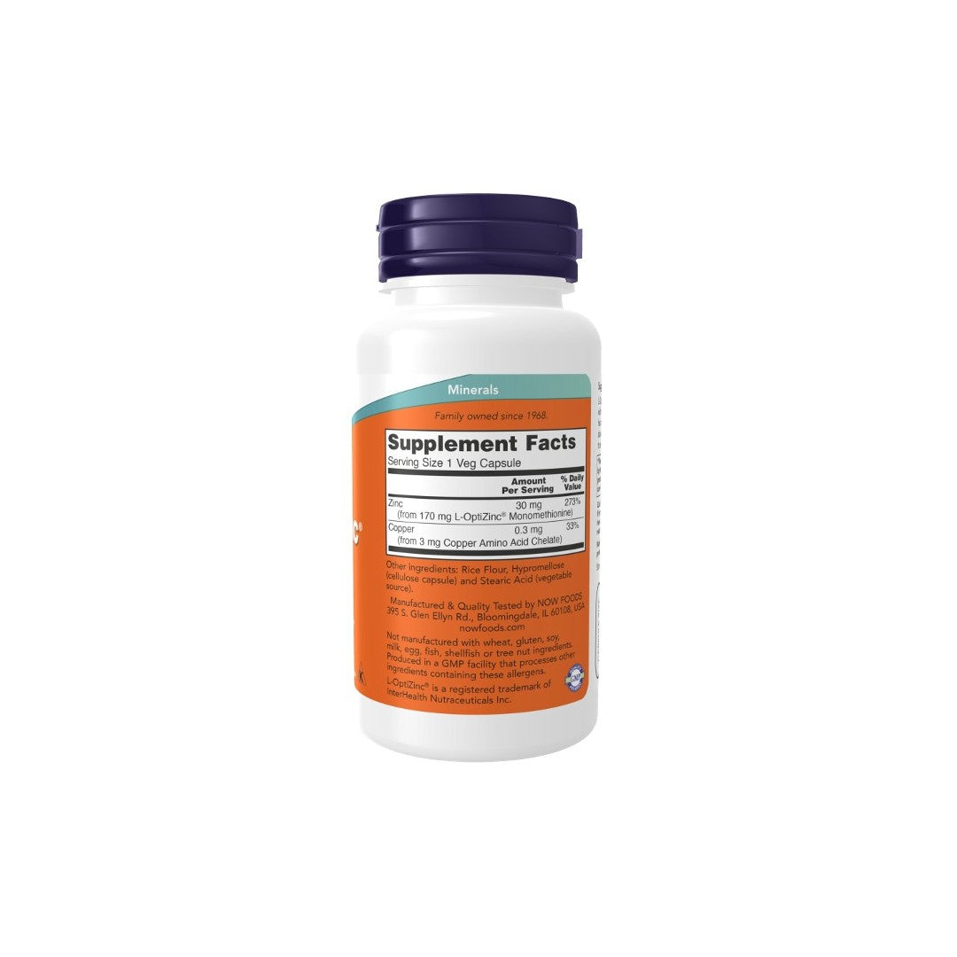 A white Now Foods supplement bottle with a blue cap featuring the Supplement Facts label. The label provides dosage information and a list of ingredients on an orange background, emphasizing key benefits such as immune system support and eyesight health with L-OptiZinc 30 mg in each of the 100 vegetarian capsules.