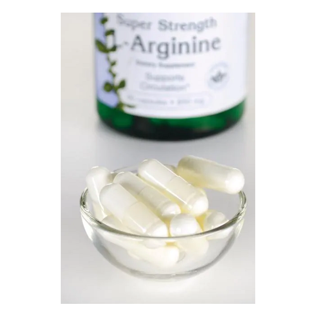 A small glass bowl with white capsules takes center stage, while a blurry Swanson supplement bottle labeled "L-Arginine 850 mg 90 Capsules - Maximum Strength" looms in the background, suggesting its benefits for circulatory health and athletic performance.