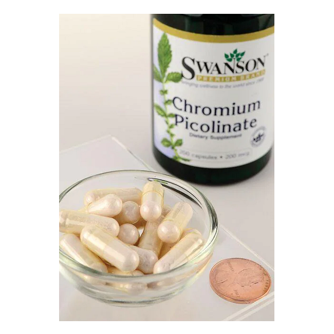 A small glass bowl holds white capsules beside a bottle labeled "Swanson Chromium Picolinate 200 mcg 200 Capsules," associated with weight loss support. A penny nearby provides size reference.