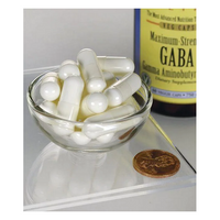 Thumbnail for A small glass bowl filled with white capsules sits next to a penny for scale, promoting sleep and relaxation, with a partially visible bottle of 