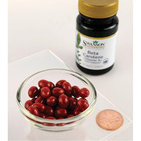 Thumbnail for Un frasco de Swanson Suplemento dietético de betacaroteno - 100 cápsulas blandas Vitamina A y un penique al lado.