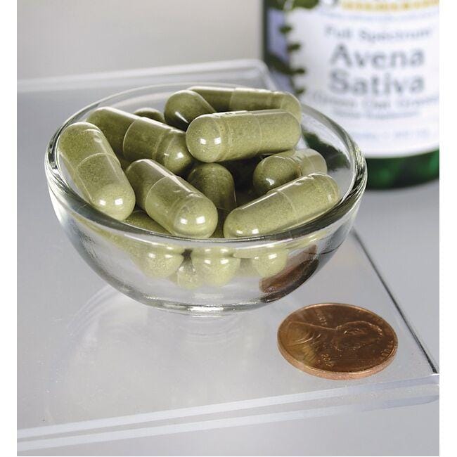 Un tazón de Swanson Avena Sativa - 400 mg 60 cápsulas junto a una botella de aceite de oliva.
