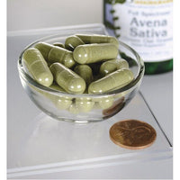 Thumbnail for Un tazón de Swanson Avena Sativa - 400 mg 60 cápsulas junto a una botella de aceite de oliva.
