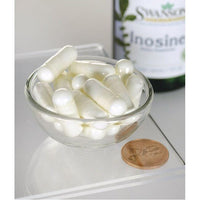 Thumbnail for Un bol de pastillas blancas junto a un frasco de Swanson Inosina - 500 mg 60 cápsulas vegetales.
