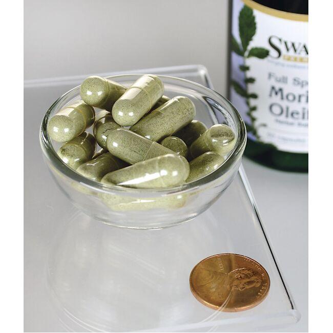 Swanson's Moringa Oleifera - 400 mg 60 cápsulas en un cuenco junto a una botella de Swanson's Moringa Oleifera, destacando los beneficios de reducir el estrés oxidativo y el daño celular.