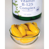 Thumbnail for A bowl of yellow Swanson Vitamin B-125 Complex - 100 Tablets with a bottle in the background, promoting a healthy nervous system and cardiovascular health.
