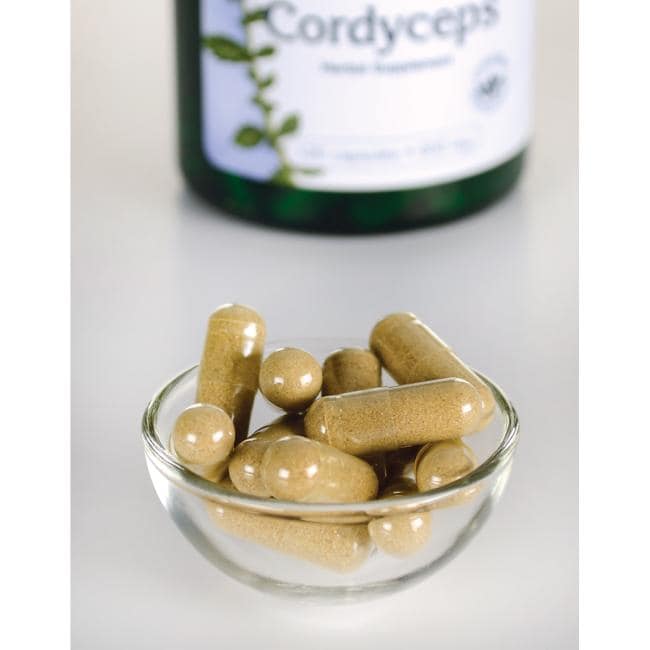 Swanson Cordyceps - 600 mg 120 cápsulas en un recipiente junto a una botella de Swanson Cordyceps.