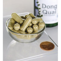 Miniatura de Swanson Dong Quai - 530 mg 100 cápsulas en un cuenco junto a un frasco.