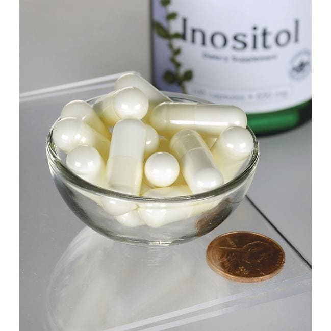 Swanson Inositol - 650 mg 100 cápsulas en un cuenco junto a una botella de Swanson Inositol.