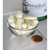Miniatura de Swanson Inositol - 650 mg 100 cápsulas en un cuenco junto a una botella de Swanson Inositol.