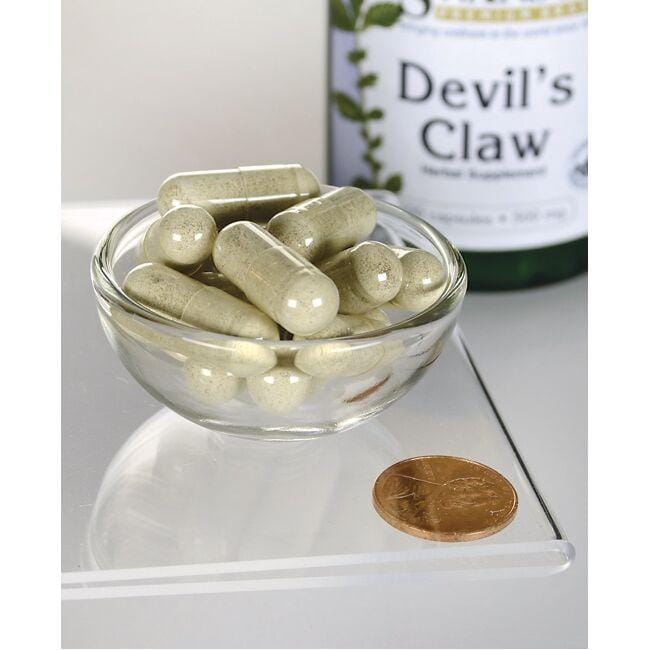 Swanson's Devil's Claw - 500 mg 100 cápsulas en un cuenco con una moneda.
