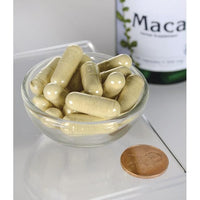 Miniatura de Swanson Maca - 500 mg 100 cápsulas en un cuenco junto a una botella de Swanson Maca.