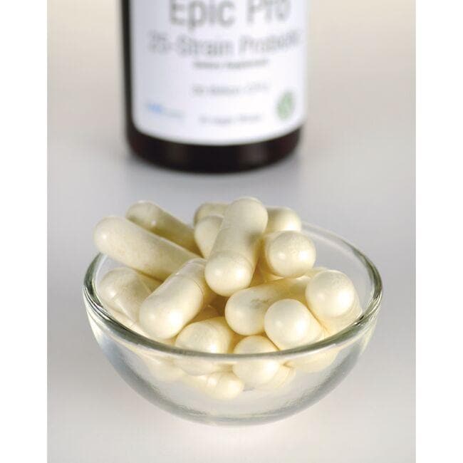 Un bol de pastillas blancas junto a una botella de Swanson's Epic Pro 25-Strain Probiotic - 30 cápsulas vegetales.