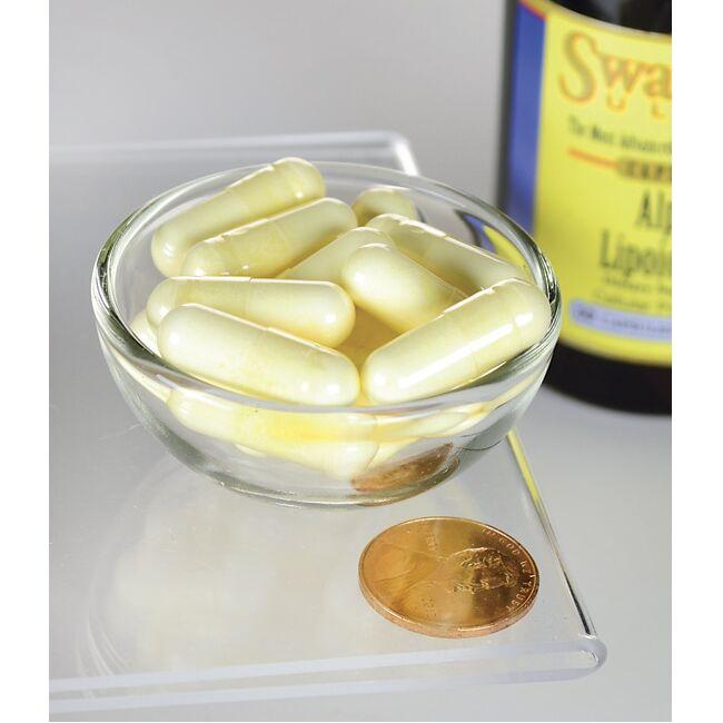 Un cuenco de Swanson Ácido Alfa Lipoico - 300 mg 60 cápsulas con una moneda al lado.