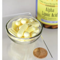 Thumbnail for Un frasco de Swanson Ácido Alfa Lipoico - 300 mg 120 cápsulas se encuentra junto a un penique.